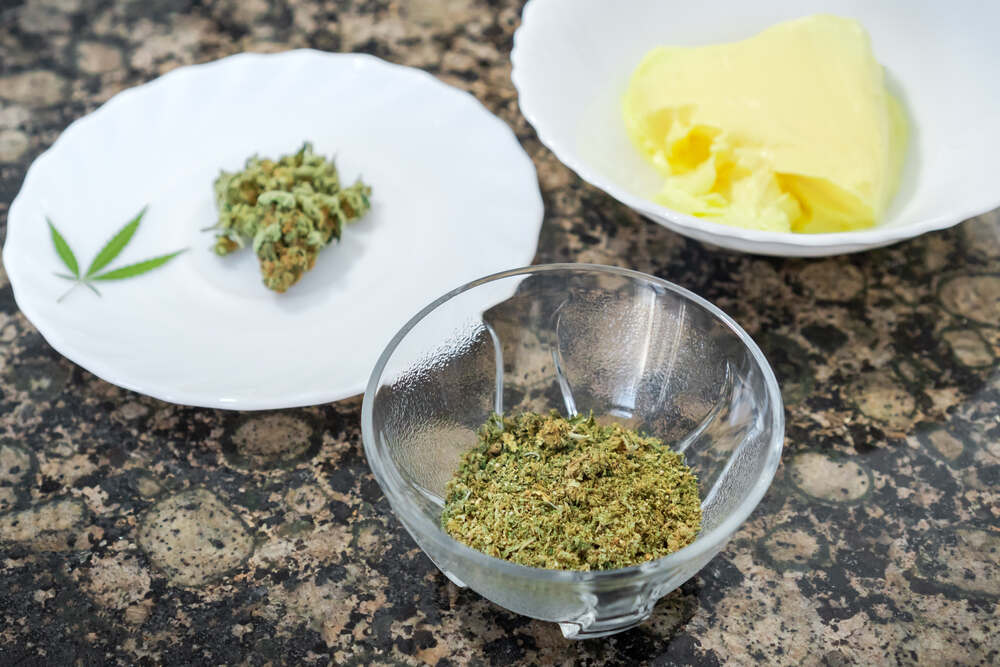 cannabis bud on plate, decarbed cannabis in bowl and butter on plate