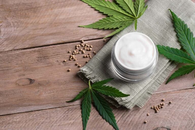 cannabis cream with cannabis seeds and marijuana leaves