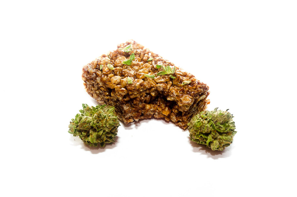 chocolate rice crispy infused with cannabis next to cannabis buds