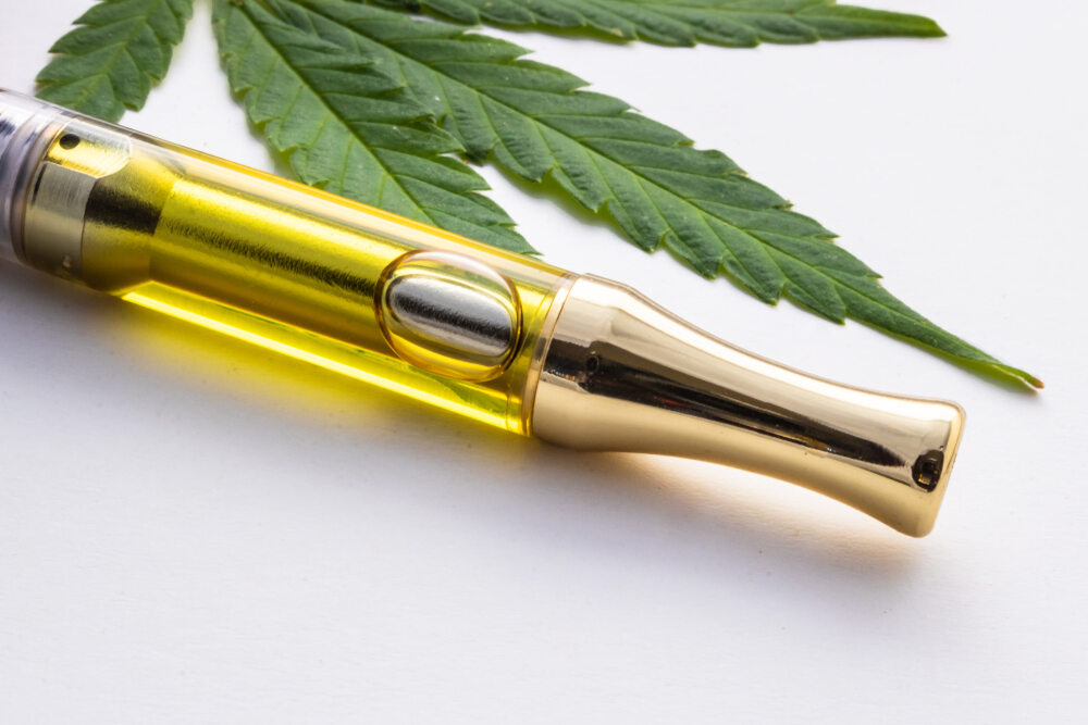 close up of cannabis vape cartridge with Marijuana Leaf