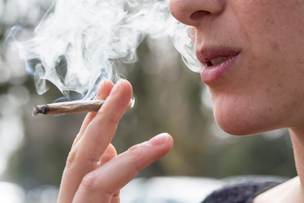 person smoking a cannabis joint