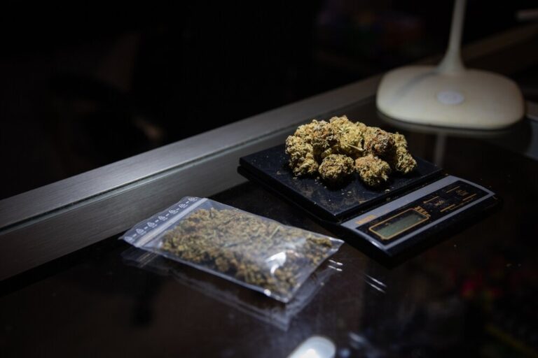 cannabis bud in ziplock baggie and on electronic scale
