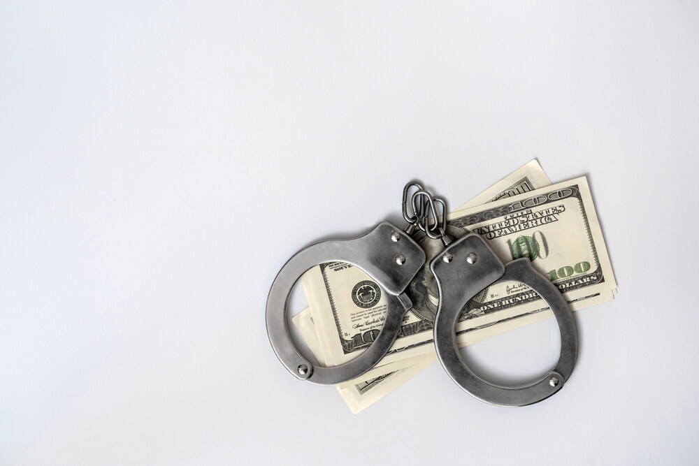 Handcuffs and US dollars