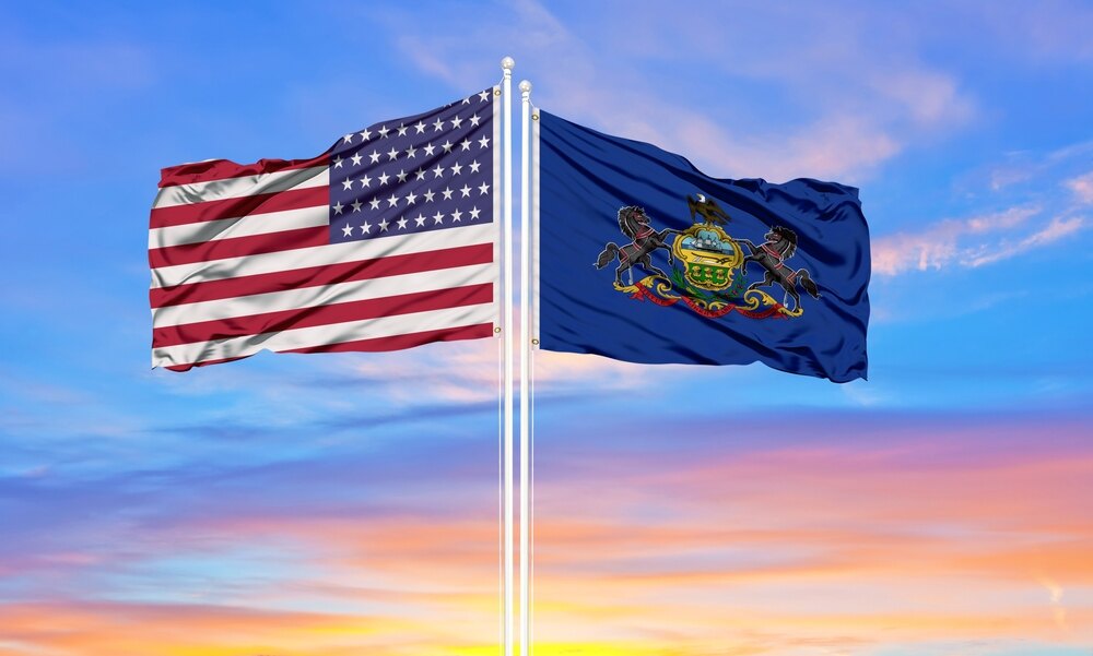 A Pennsylvania state flag next to the USA flag