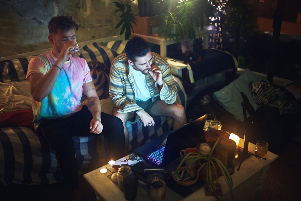 two men smoking in a cannabis lounge